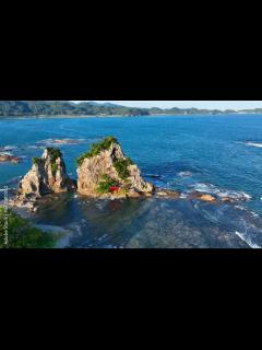 [x]picturesque seascape with a tiny rocky island with Asian shrine in ...